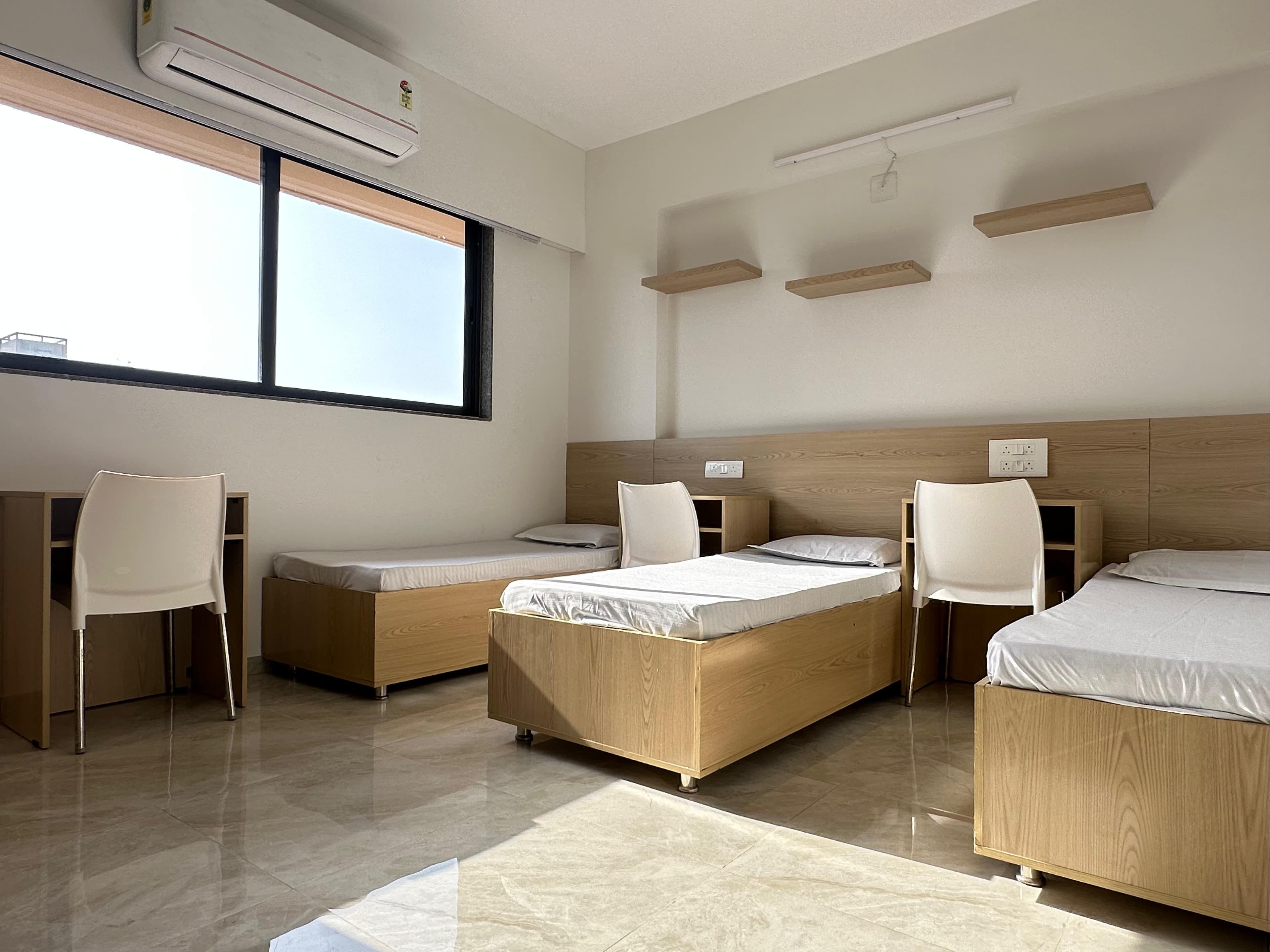 Triple Room at Unoloft PG in Ahmedabad with AC and study setup