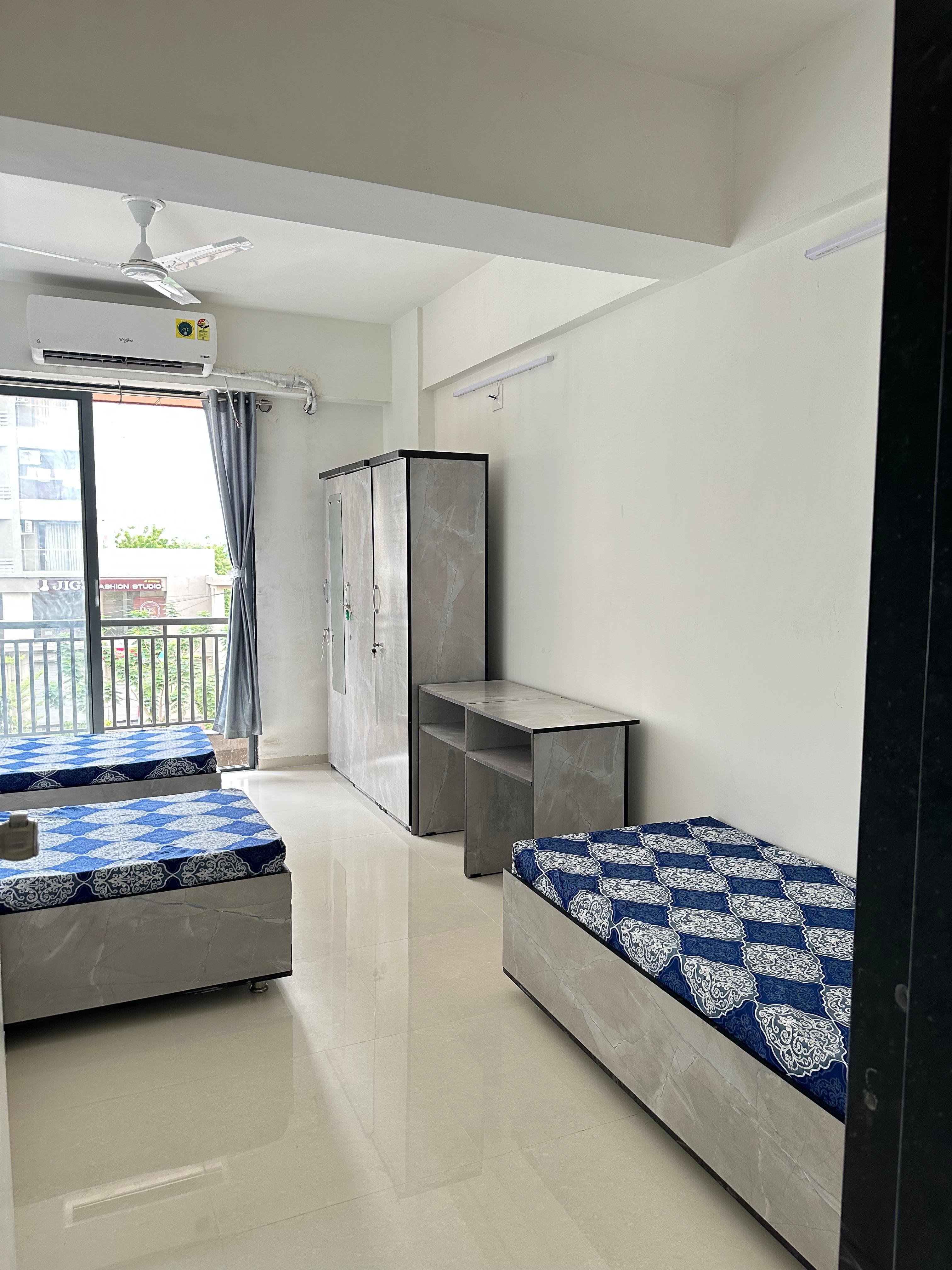 Triple Room at Unoloft PG in Ahmedabad with AC and study setup